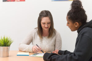 Student and employer reviewing a document at Colorado State University career center.